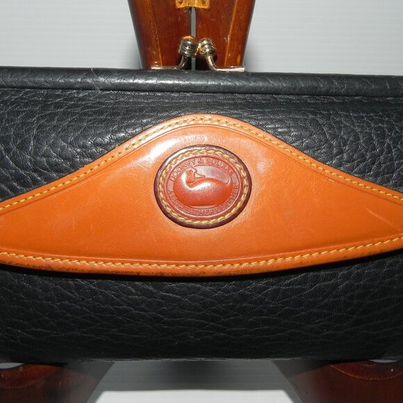 Dooney & Bourke Handbags - VTG Dooney & Bourke AWL Black Brown Trim Pebble Leather Wallet.